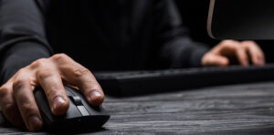 Man using computer in dark room