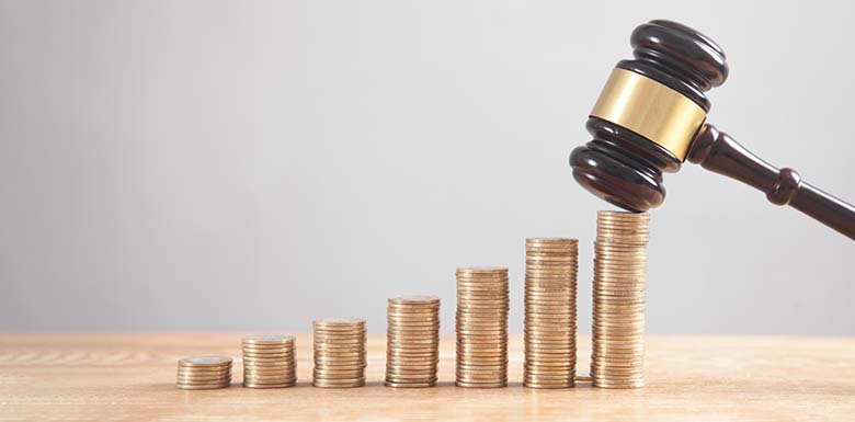 Rising stack of quarters with gavel