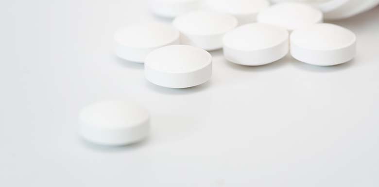 white isotonitazene pills spilled across table